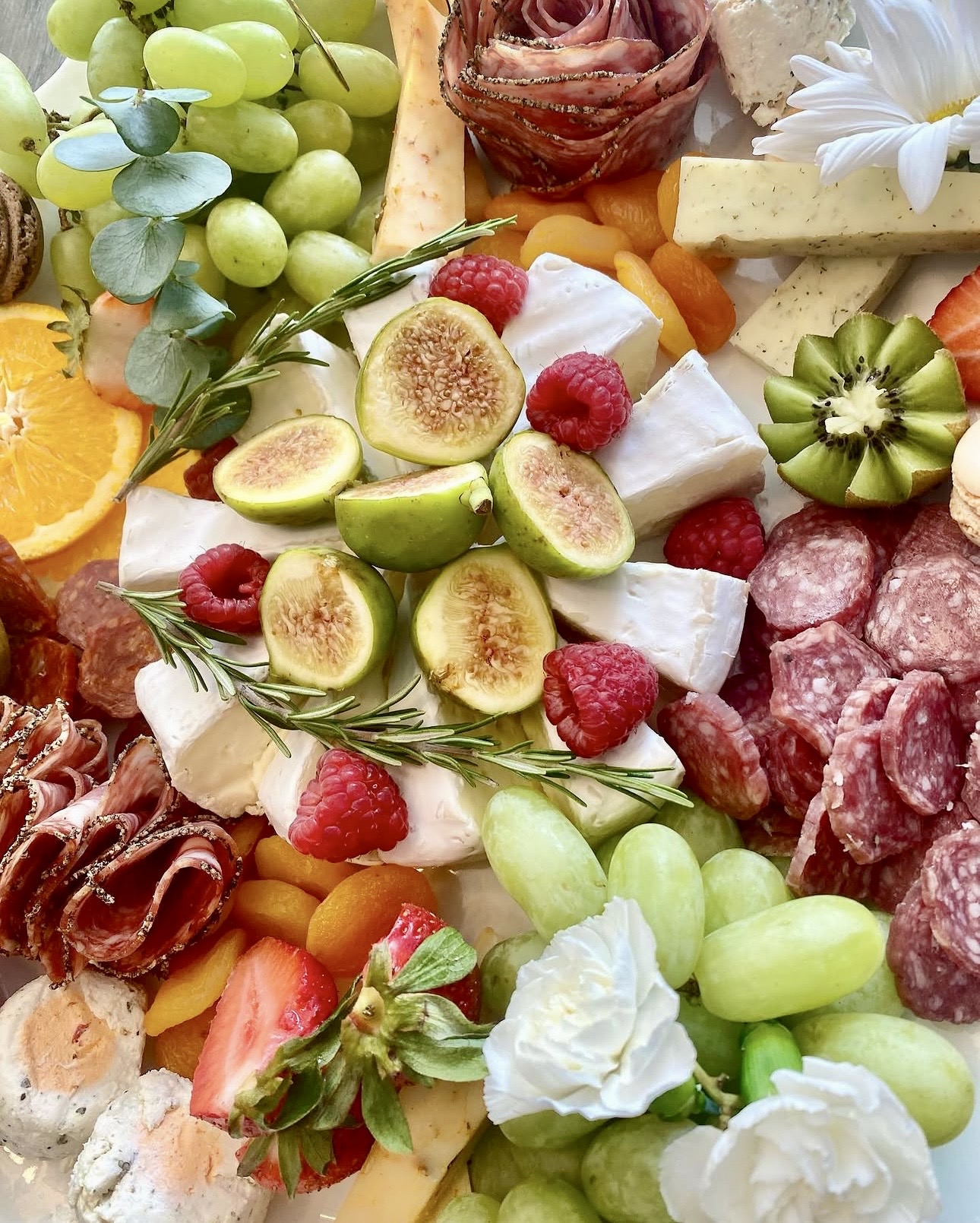 Hunt & Honey charcuterie board with figs, raspberries, brie, salami roses and fresh fruit